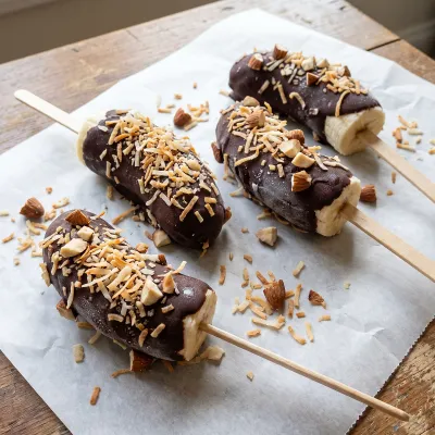 Frozen Dark Chocolate Dipped Banana Pops with Toasted Coconut and Crushed Almonds